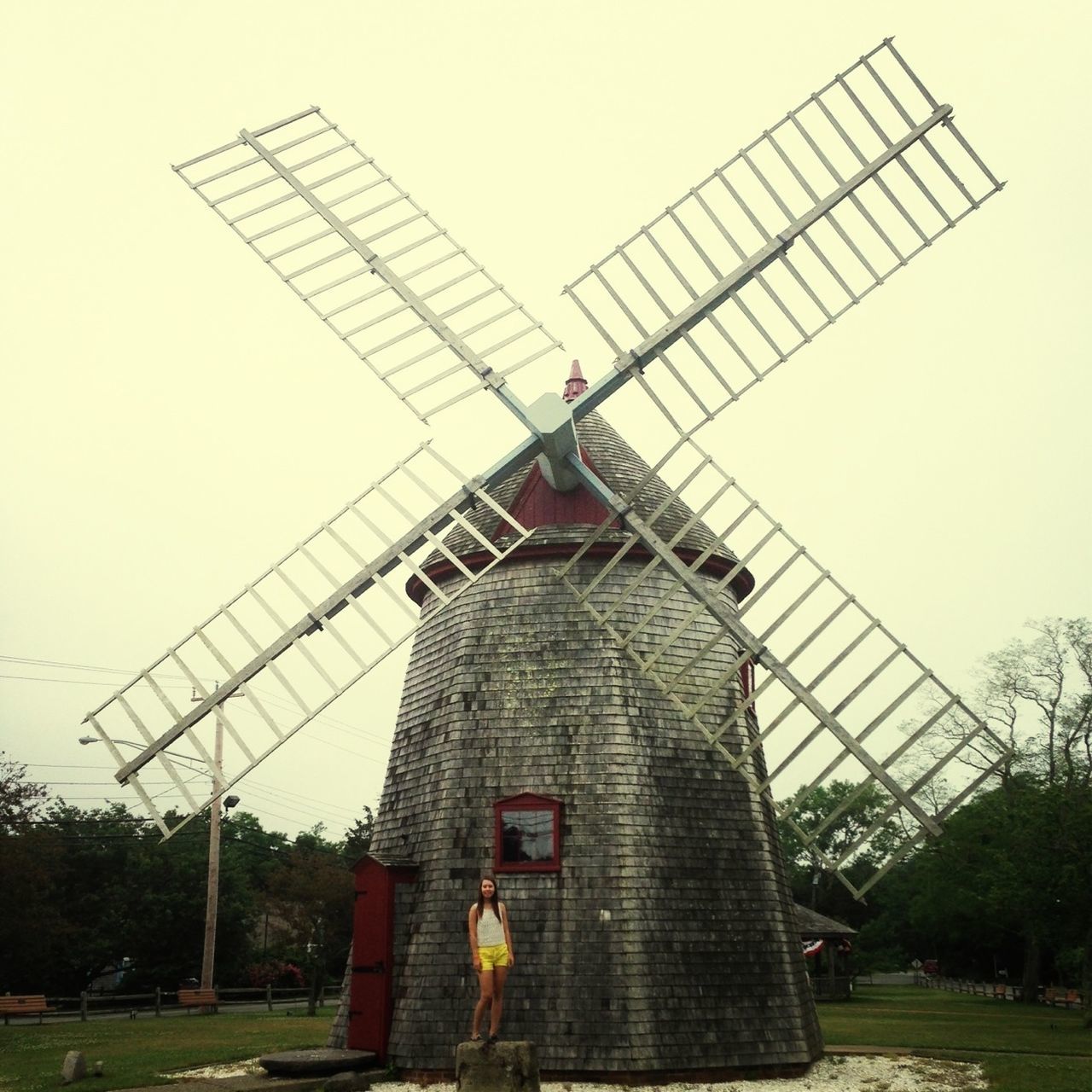 built structure, building exterior, architecture, clear sky, fuel and power generation, low angle view, sky, renewable energy, alternative energy, traditional windmill, wind power, windmill, technology, tree, crane - construction machinery, environmental conservation, day, outdoors