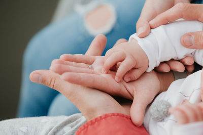 Close-up of baby hand over hand of parents