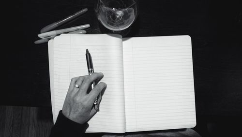 Cropped image of hand holding book