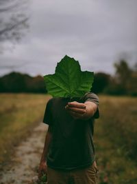 Man standing on land against sky