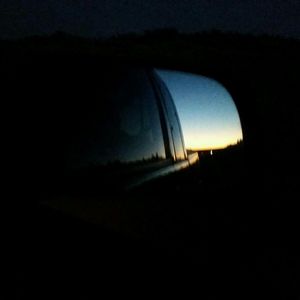 Silhouette landscape against sky at night