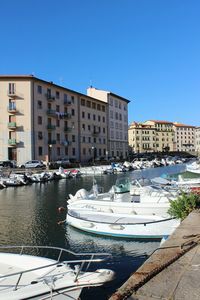 View of buildings against clear blue sky