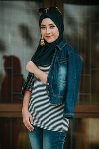 Portrait of a smiling young woman standing outdoors