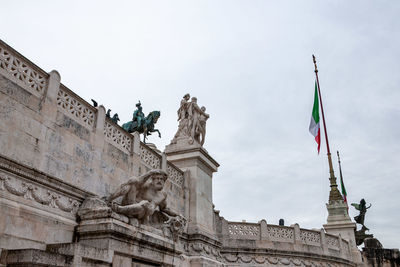 Low angle view of statues against sky