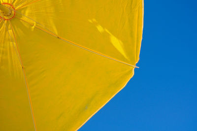 Low angle view of yellow leaf against clear sky