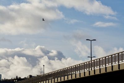 Low angle view of bridge against cloudy sky