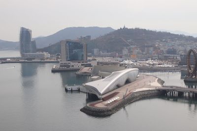 Boats in river with city in background