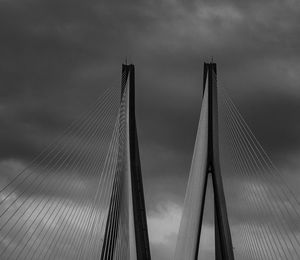 Low angle view of bandraworli sea link against cloudy sky