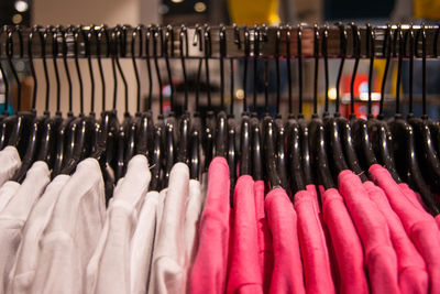 Clothes hanging in row at store