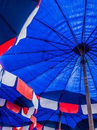 Low angle view of flags against blue sky