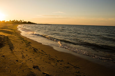 Scenic view of beach against sky during sunset