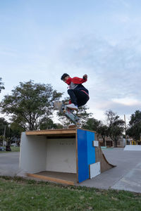 Portrait of skateboarder jumping in a ramp