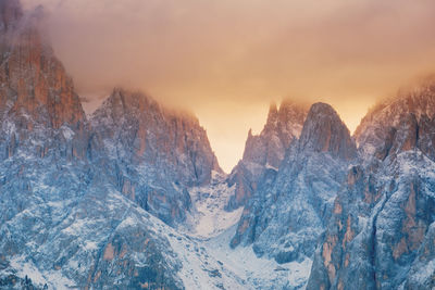 Scenic view of snowcapped mountains against sky during sunset