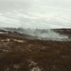 Scenic view of mountains against sky during foggy weather