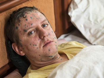 Portrait of man lying in bed