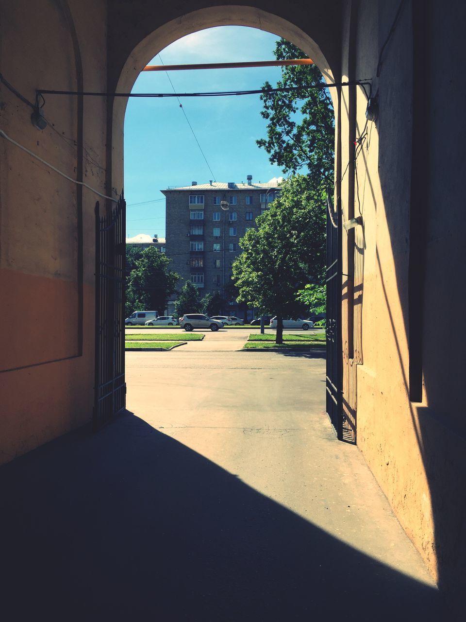 architecture, built structure, building exterior, arch, window, indoors, tree, building, the way forward, city, archway, entrance, street, residential structure, door, house, clear sky, residential building, day, sunlight