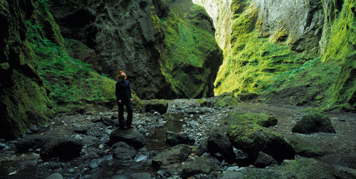 Woman admiring the canyon walls of stakkholtsgjá canyon at thorsmork