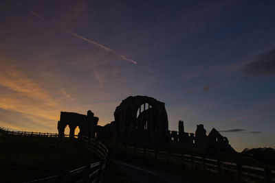 Silhouette of temple against sky during sunset