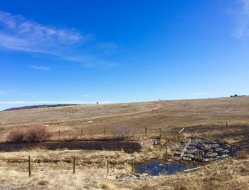 Scenic view of landscape against blue sky
