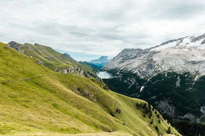 Panoramic view of lake fedaia and the marmolada glacier.