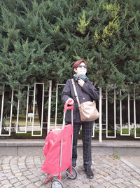 Full length portrait of man standing on footpath