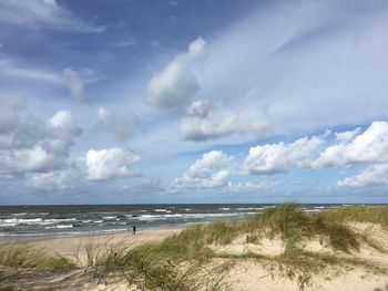 View of beach against cloudy sky