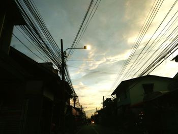 Low angle view of silhouette buildings against sky