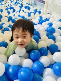 Portrait of cute smiling boy with ball