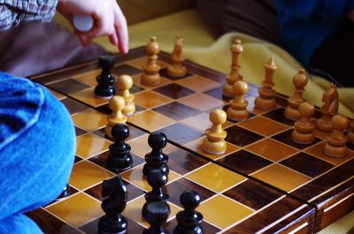 Low angle view of man playing on chess board