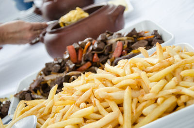 Close-up of person preparing food on plate