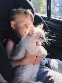 Close-up of boy holding cat