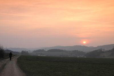 Scenic view of field against sky during sunset