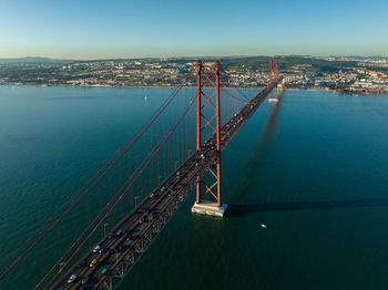 The 25 april bridge ponte 25 de abril located in lisbon, portugal, crossing the targus river. drone.