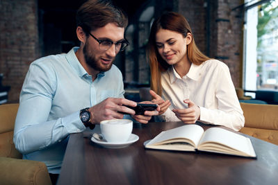 Young couple sitting on table