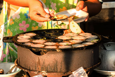 Midsection of man preparing food