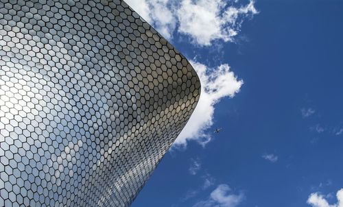 Low angle view of building against cloudy sky