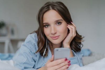 Portrait of young woman using mobile phone