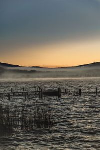 Scenic view of lake against sky during sunset