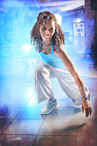 Portrait of cheerful young woman dancing on floor