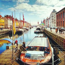 Boats in canal along buildings