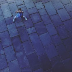 High angle view of woman standing on footpath