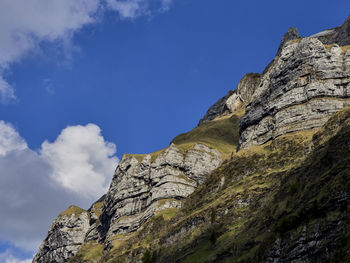 Low angle view of rocky mountains against sky