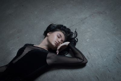 High angle view of woman lying on ground