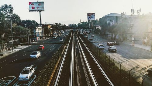 High angle view of railroad tracks on road in city