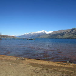 Scenic view of sea against clear blue sky