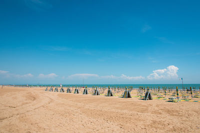 Scenic view of beach against blue sky