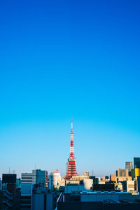 Modern buildings in city against blue sky