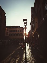 Street lights in city against sky