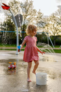 Side view of girl playing with toy car