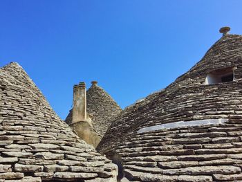 Low angle view of old building against blue sky